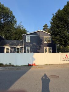 Exterior of the Reading home addition with dark siding and white window trim