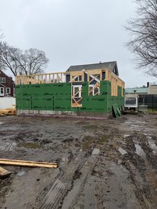 Wood framing and exterior wall sheathing being installed on a residential home addition