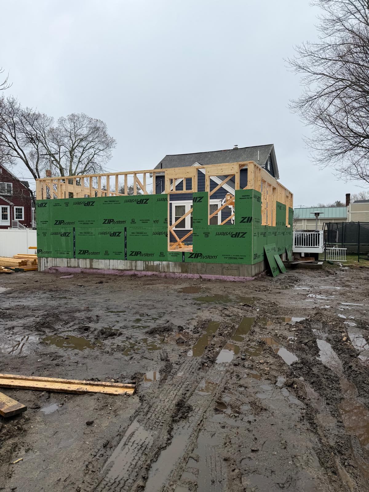 Wood framing and exterior wall sheathing being installed on a residential home addition