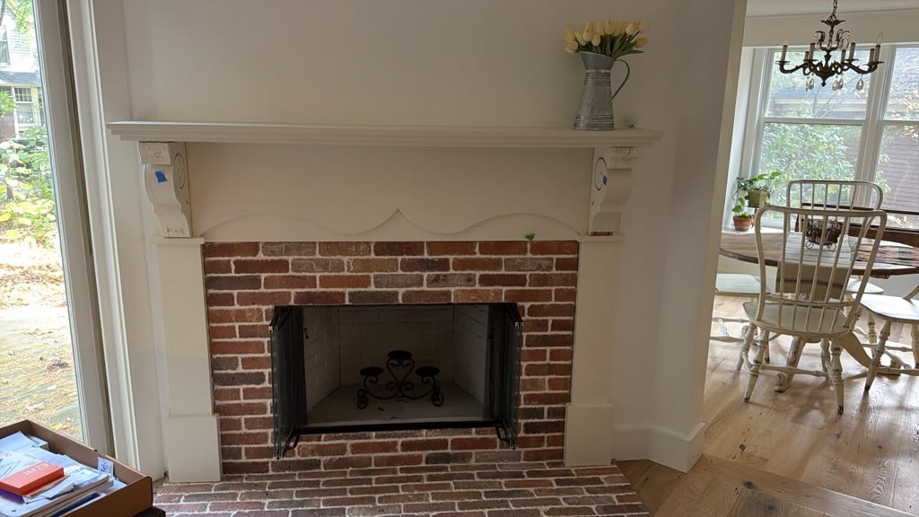 Brick fireplace with a painted mantel in the Hudson home