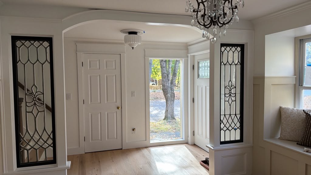 Remodeled Hudson living space with decorative glass doors and reclaimed flooring